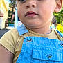 child, toddler, face, cap, hat, overalls, clothing, outdoor, portrait, young_child, casual_wear, daylight, curious, cute, person, baby, skin, expression, summer, nature