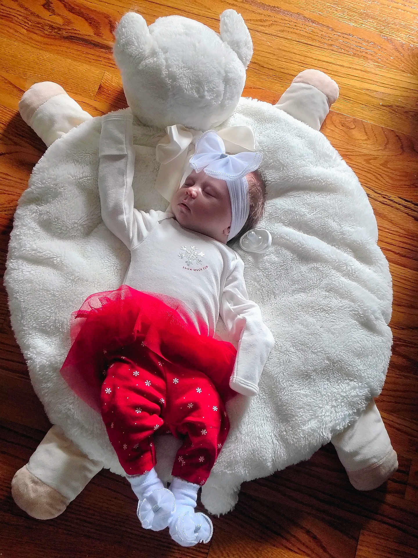 Clara joined the competition — help win amazing prizes! baby, infant, sleeping, headband, bow, red_pants, white_top, pacifier, plush_cushion, bear_shape, wooden_floor, cozy, cute, toddler, child, indoors, soft_texture, resting, peaceful, adorable