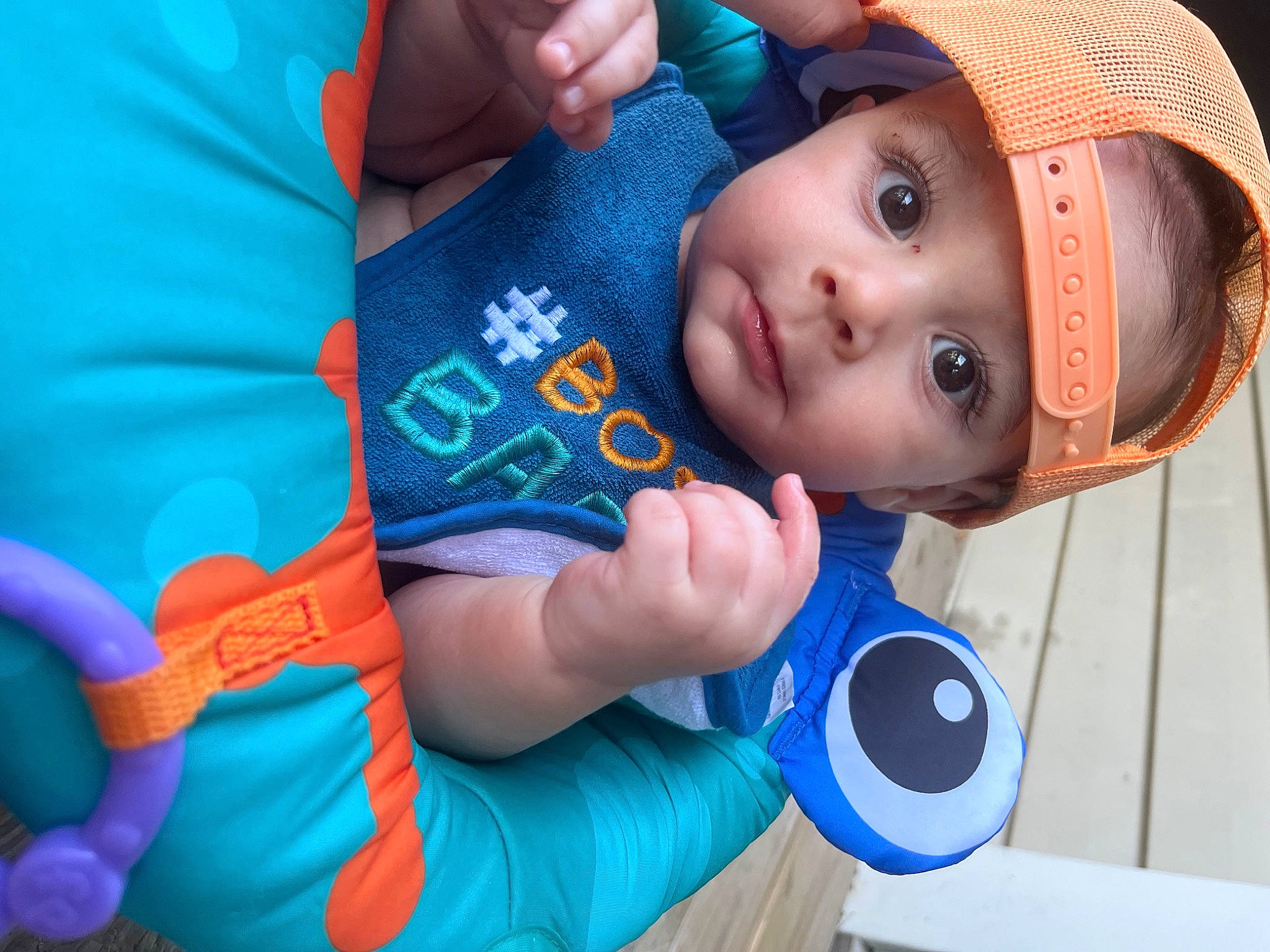 Kyson is registered to the contest to win money with this photo: azure, baby, baby_products, baby_toddler_clothing, blue, cap, child, elbow, electric_blue, facial_expression, fashion_accessory, fun, happy, hat, headwear, leisure, mouth, nose, person, play