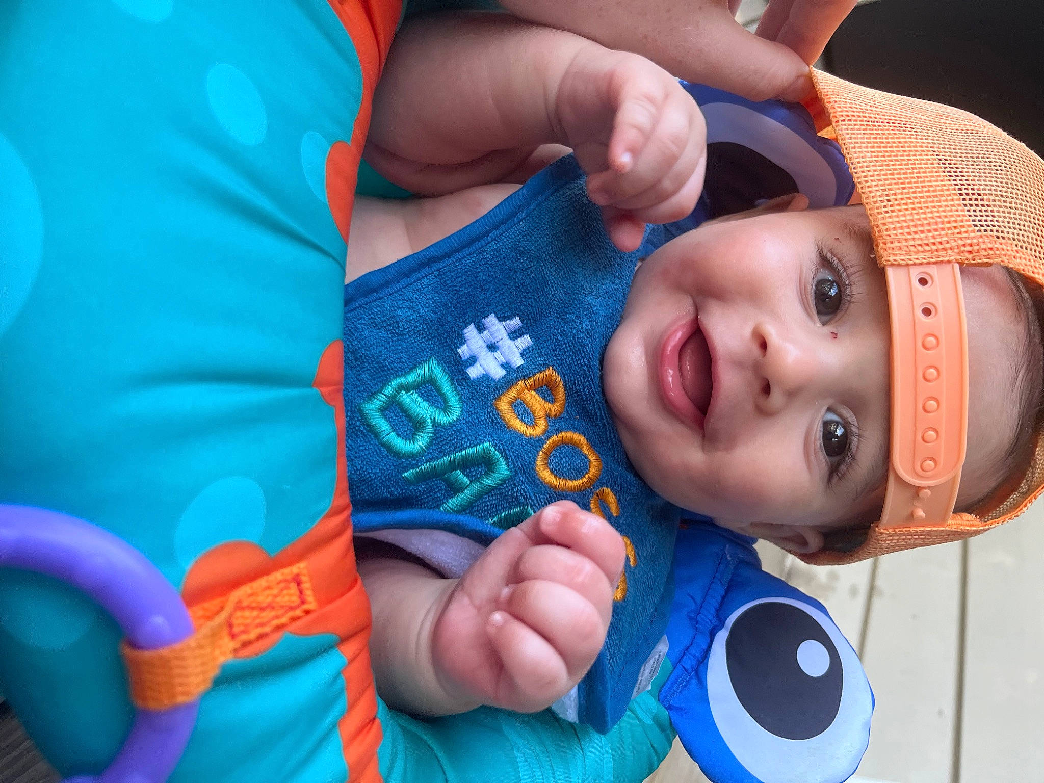 Kyson is registered to the contest to win money with this photo: azure, baby, child, elbow, electric_blue, finger, fun, gesture, hand, happy, hat, headwear, human_body, leisure, mouth, nail, nose, person, skin, smile