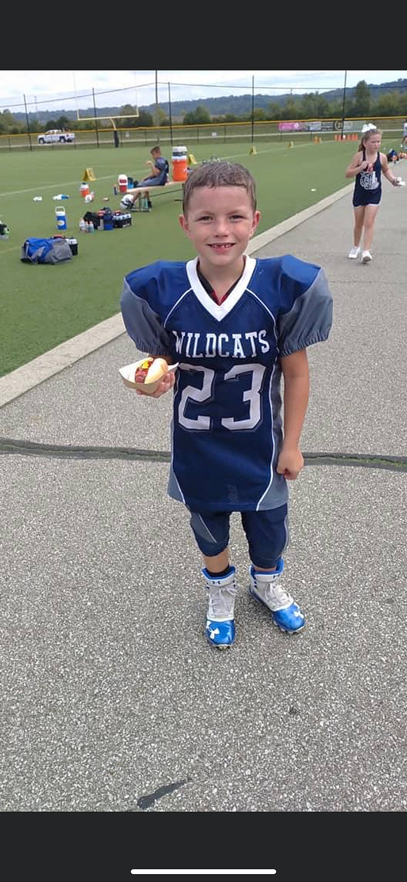 Landyn is registered to the contest to win money with this photo: ball_game, blue, blurred, championship, competition_event, electric_blue, grass, jersey, joy, person, player, recreation, running, smile, sneakers, sports, sports_uniform, sportswear, t_shirt, team_sport