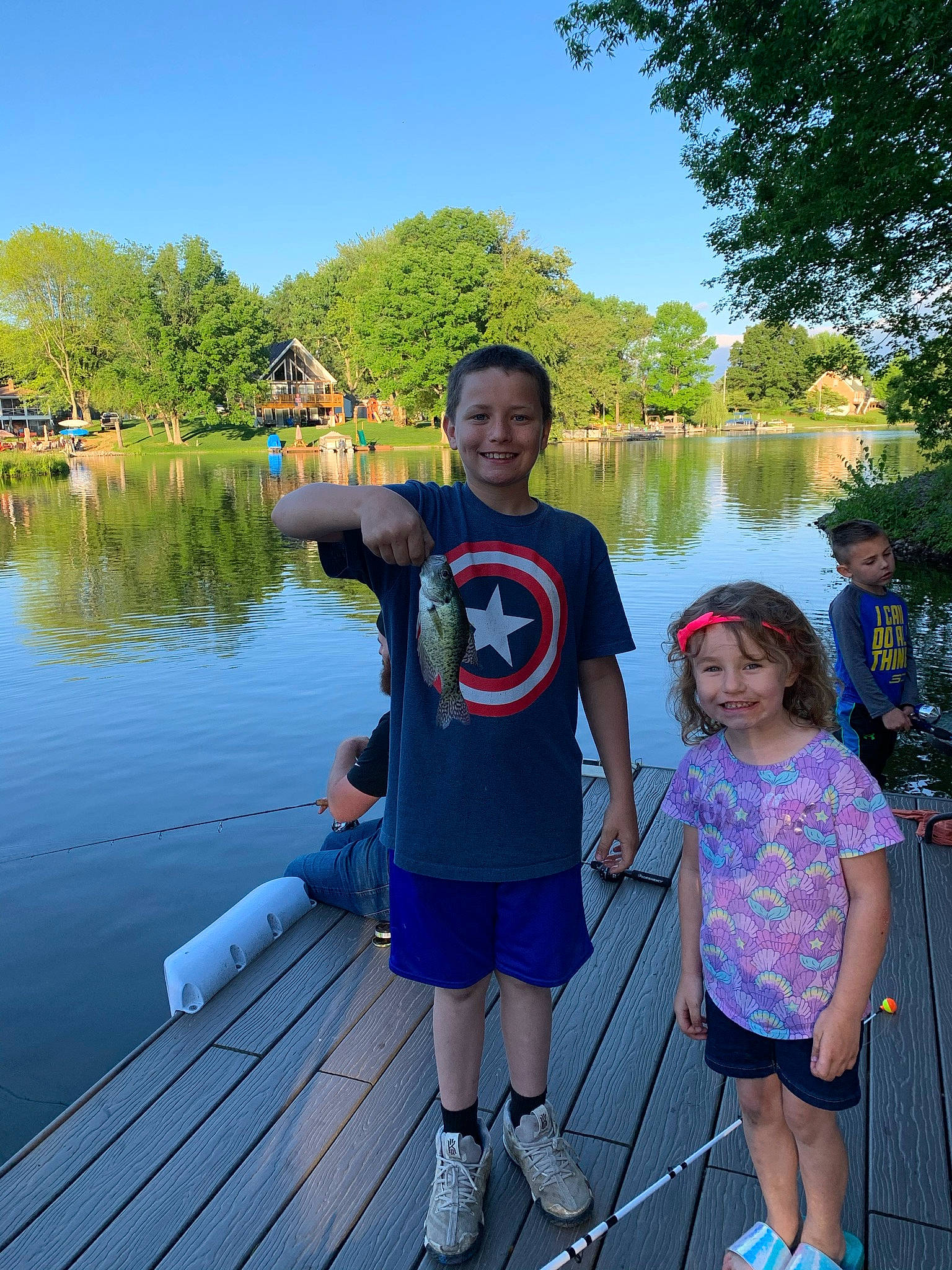 Ayden is registered to the contest to win money with this photo: bank, boats_and_boating_equipment_and_supplies, body_of_water, botany, fun, happy, headwear, joy, lake, leisure, morning, outdoor_recreation, person, plant, recreation, shorts, sky, smile, t_shirt, travel
