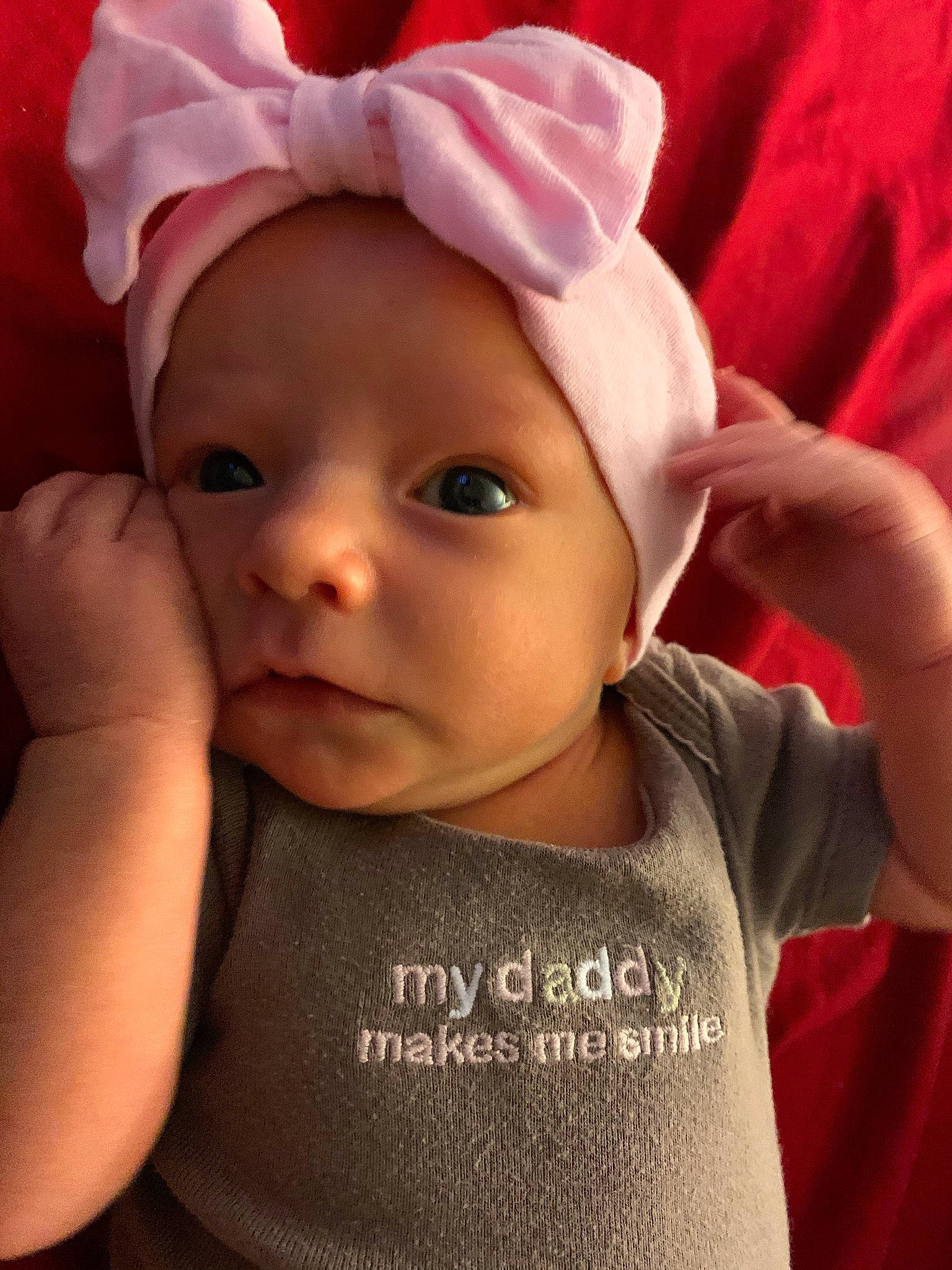 Paisley joined the competition — help win amazing prizes! baby, baby_toddler_clothing, cap, cheek, eye, eyebrow, eyelash, face, gesture, happy, head, headwear, human_body, iris, lip, mouth, nose, person, pink, skin