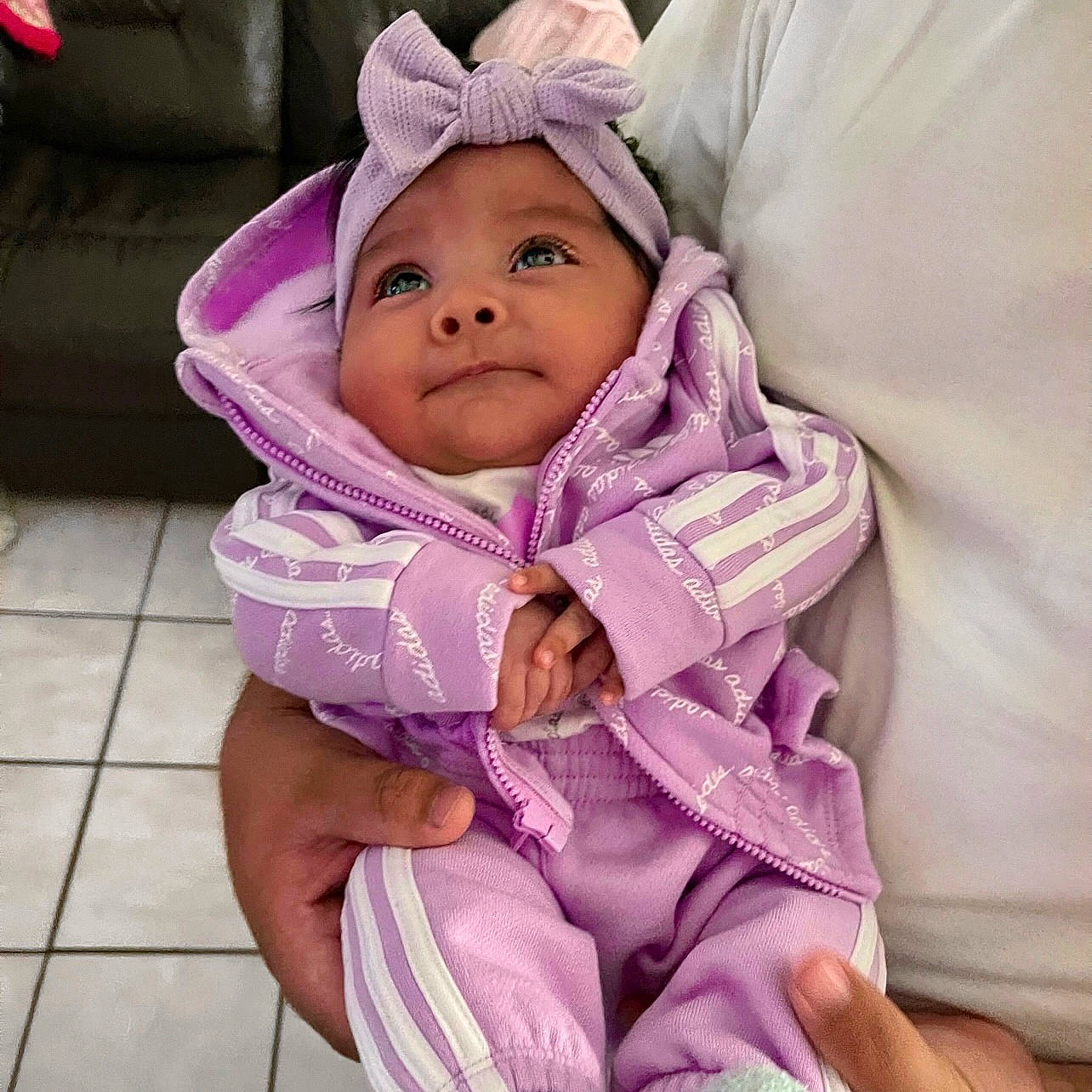 Aubrielle is registered to the contest to win money with this photo: baby, baby_products, baby_safety, baby_toddler_clothing, cheek, child, comfort, fashion_accessory, happy, headwear, hood, jacket, linens, magenta, person, pink, purple, sitting, sleeve, smile