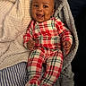 Karter is registered to the contest to win money with this photo: baby, blanket, child, closeup, comfort, cozy, cute, expression, happy, indoor, infant, lying_down, person, plaid_pajamas, portrait, resting, sleepwear, smiling, soft_texture, warm