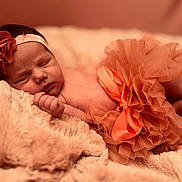 Isla joined the competition — help win amazing prizes! newborn, baby, sleeping, headband, flower, tutu, blanket, soft, closeup, infant, cute, resting, peaceful, skin, portrait, fuzzy, pink, orange, cozy, delicate