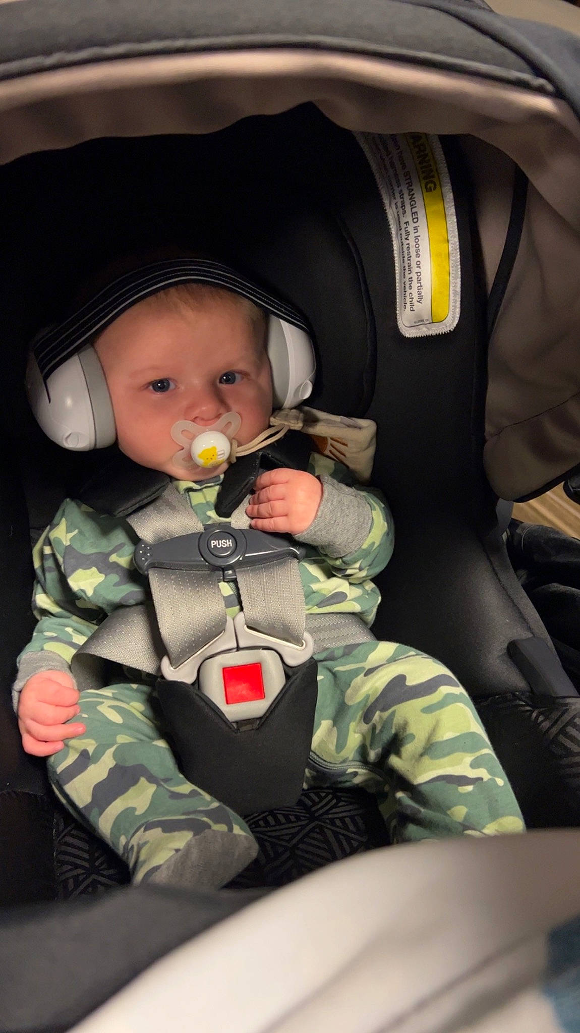 Gage is registered to the contest to win money with this photo: army, auto_part, baby, camouflage, car_seat, child, comfort, gesture, headwear, military_camouflage, military_organization, military_person, military_uniform, outerwear, pattern, person, personal_protective_equipment, seat_belt, sitting, soldier