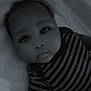 Lucas is registered to the contest to win money with this photo: baby, infant, child, face, portrait, striped_clothing, blanket, lying_down, closeup, monochrome, black_and_white, cute, eyes, soft_light, indoor, young_child, head, skin, person, newborn