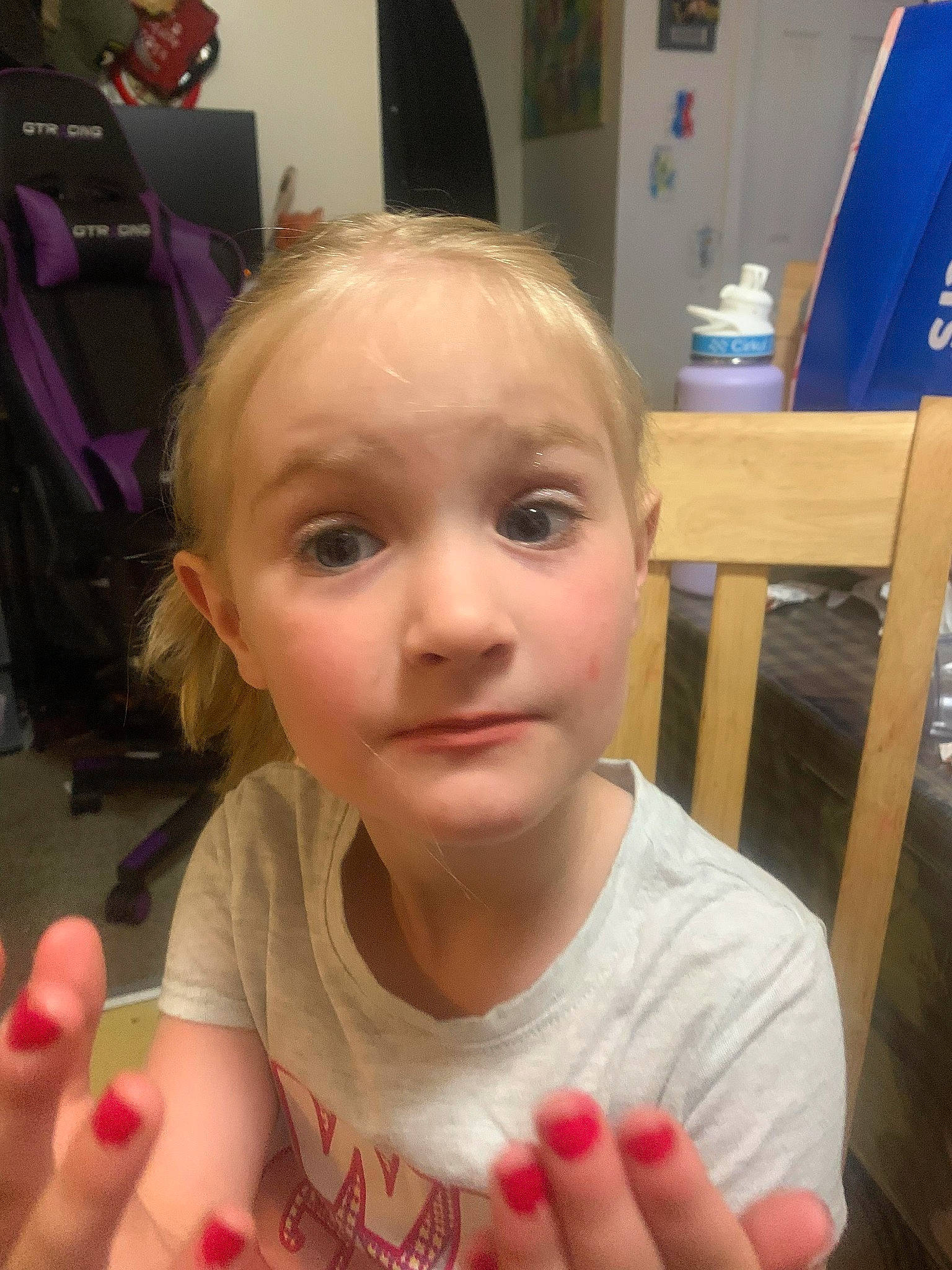 Olivia is registered to the contest to win money with this photo: chair, cheek, child, chin, ear, eyelash, face, finger, fun, gesture, happy, iris, lip, mouth, nail, nose, person, skin, t_shirt, thumb