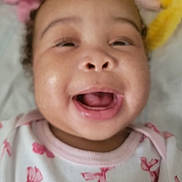 Nylah is registered to the contest to win money with this photo: baby, smiling, close_up, infant, pink_bows, clothing, face, mouth_open, blanket, soft, cute, child, indoors, happy, young, person, cheeks, expression, apparel, head