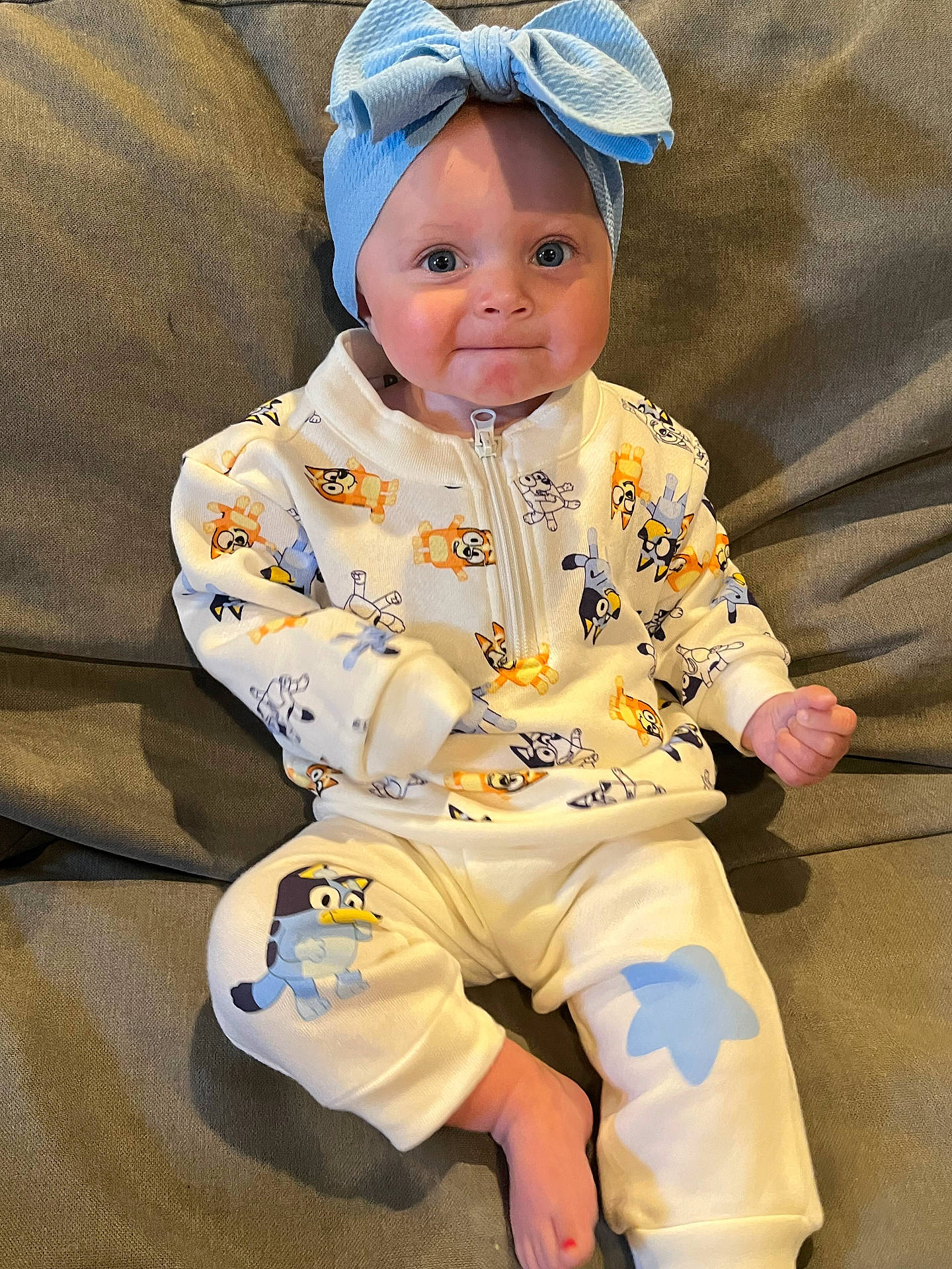 Ronnie is registered to the contest to win money with this photo: baby, beachwear, clothing, face, food, hat, head, pajamas, person, photography, portrait, sitting, sleeve, spitting, stain, toy
