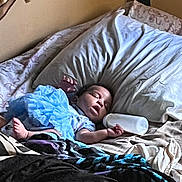 Aurora joined the competition — help win amazing prizes! baby, infant, sleeping, bed, pillow, blanket, bedding, bottle, nursery, home, indoors, portrait, face, eyes_closed, mouth_open, lying_down, blue_clothing, floral_pattern, cozy, resting