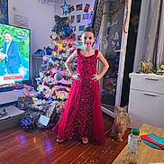 Justine participe au concours pour gagner de l'argent avec cette photo : child, girl, red_dress, christmas_tree, christmas_lights, gifts, dog, living_room, television, floor, glass_door, holiday_decor, ornaments, furniture, person, flooring, decorations, smiling, standing, indoors