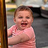 Charlotte joined the competition — help win amazing prizes! baby, child, smiling, happy, pink_onesie, striped_clothing, outdoor, pole, golden_pole, face, cute, infant, teeth, joy, holding, sitting, blurred_background, daylight, person, portrait