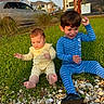 child, children, baby, toddler, pajamas, grass, rocks, outdoor, play, smiling, happy, sunlight, daylight, tree, car, house, nature, footwear, sitting, fun