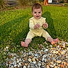 baby, child, grass, pebbles, outdoor, yellow_onesie, funny_face, barefoot, sunlight, suburban, tree, car, house, greenery, cute, sitting, nature, daylight, portrait, expression