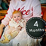 Preszley joined the competition — help win amazing prizes! adult, baby, blanket, child, circular_board, clothing, cozy, cute, four_months, hand_in_mouth, indoor, infant, lap, milestone_sign, parent, pink_sweatshirt, portrait, red_nails, sitting, yellow_socks