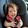 baby, child, car_seat, seatbelt, blue_eyes, pink_clothing, hair, tongue, hand, infant, smiling, sitting, safety, child_seat, cute, indoors, car, portrait, person, happy