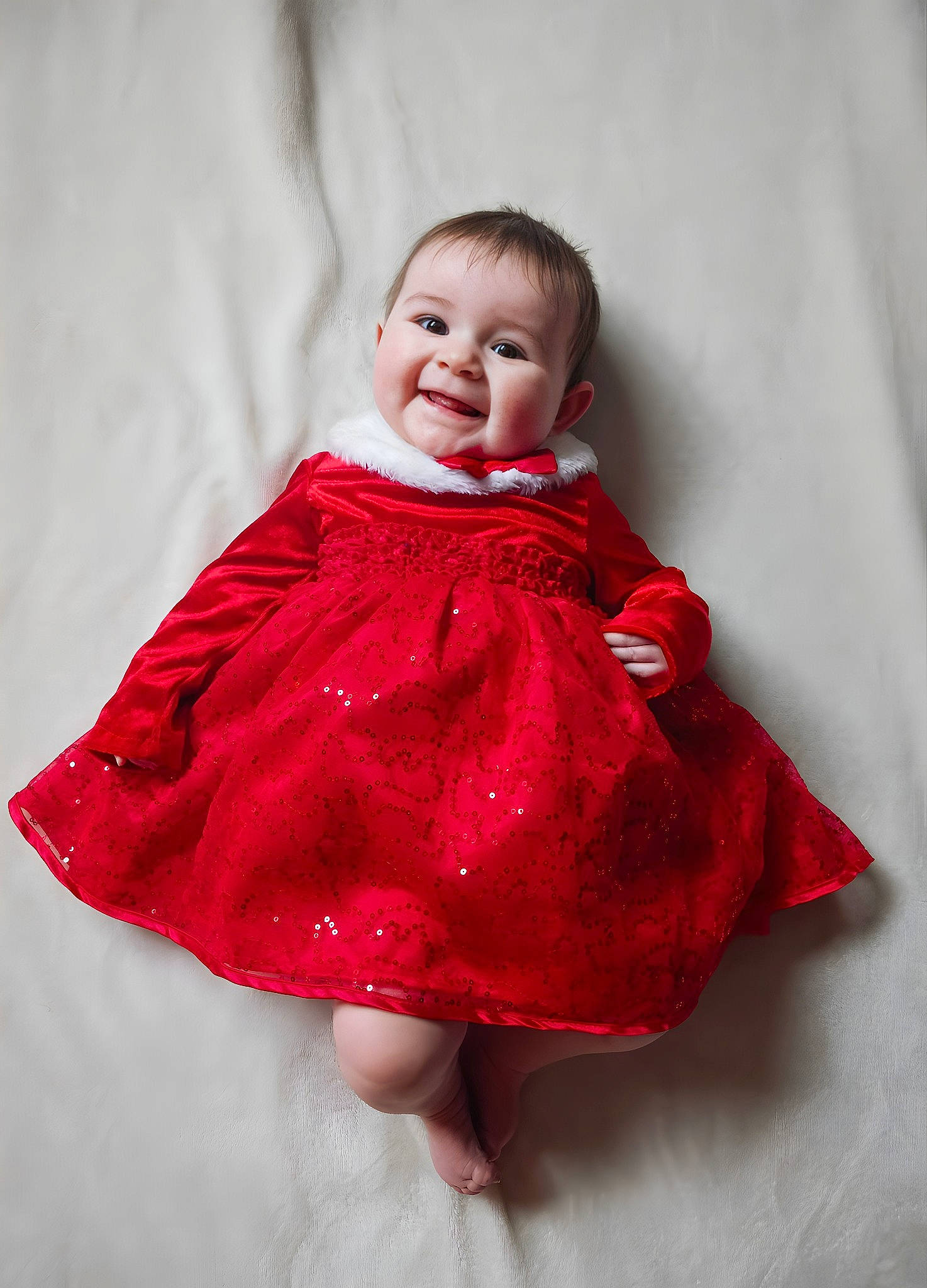 Ellie Mae is registered to the contest to win money with this photo: baby, baby_toddler_clothing, day_dress, dress, embellishment, event, fashion_design, flash_photography, formal_wear, gesture, happy, head, joy, magenta, one_piece_garment, pattern, person, pink, purple, sleeve