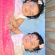 Monserrat is registered to the contest to win money with this photo: baby, sleeping, crib, blanket, pink, blue, flower_clip, infant, cute, peaceful, child, toddler, resting, hair_accessory, bed, soft_texture, adorable, indoor, two_babies, holding_hands