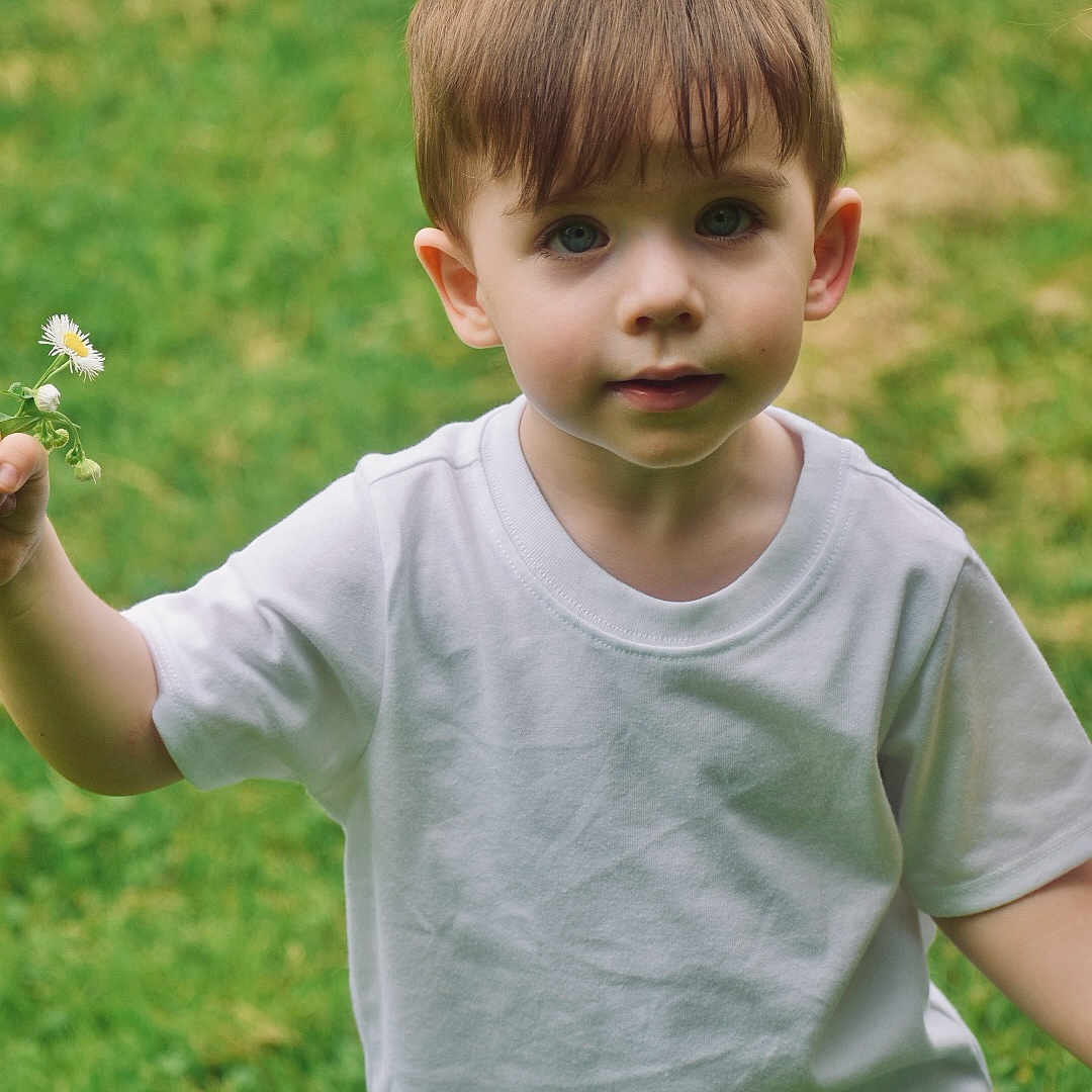 Kai joined the competition — help win amazing prizes! bodypart, boy, child, clothing, face, finger, flower, grass, hand, head, jeans, lawn, male, pants, person, photography, plant, portrait, sleeve, t_shirt