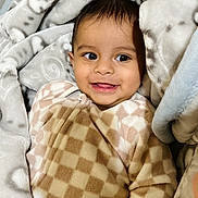 Aarvik is registered to the contest to win money with this photo: baby, smiling, blanket, cozy, soft, plush, onesie, child, face, happy, indoors, cute, warm, comfort, infant, sleepwear, portrait, young, head, skin