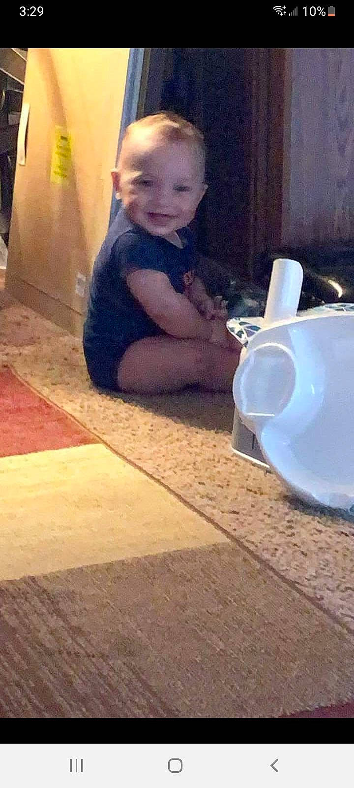 Chevy is registered to the contest to win money with this photo: asphalt, baby, child, cloud, drinkware, flooring, fun, hairstyle, happy, human_leg, joy, person, play, road_surface, serveware, sidewalk, sitting, smile, square, tints_and_shades