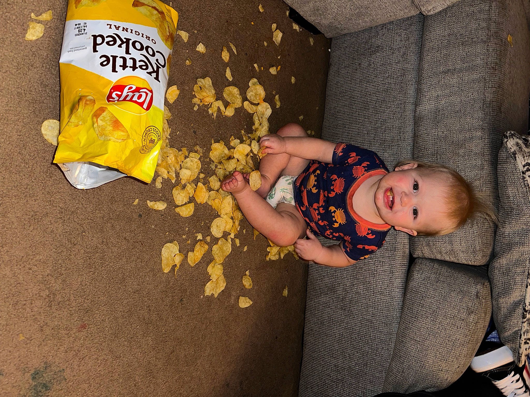 Levi is registered to the contest to win money with this photo: baby, baby_products, baby_toddler_clothing, child, comfort, flooring, food, fun, joy, logo, pattern, person, snack, toddler