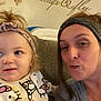 Lila joined the competition — help win amazing prizes! toddler, woman, headband, couch, indoor, wall_decal, butterfly, smile, portrait, casual_clothing, child, adult, family, home, cozy, funny_face, patterned_outfit, person, head, closeup