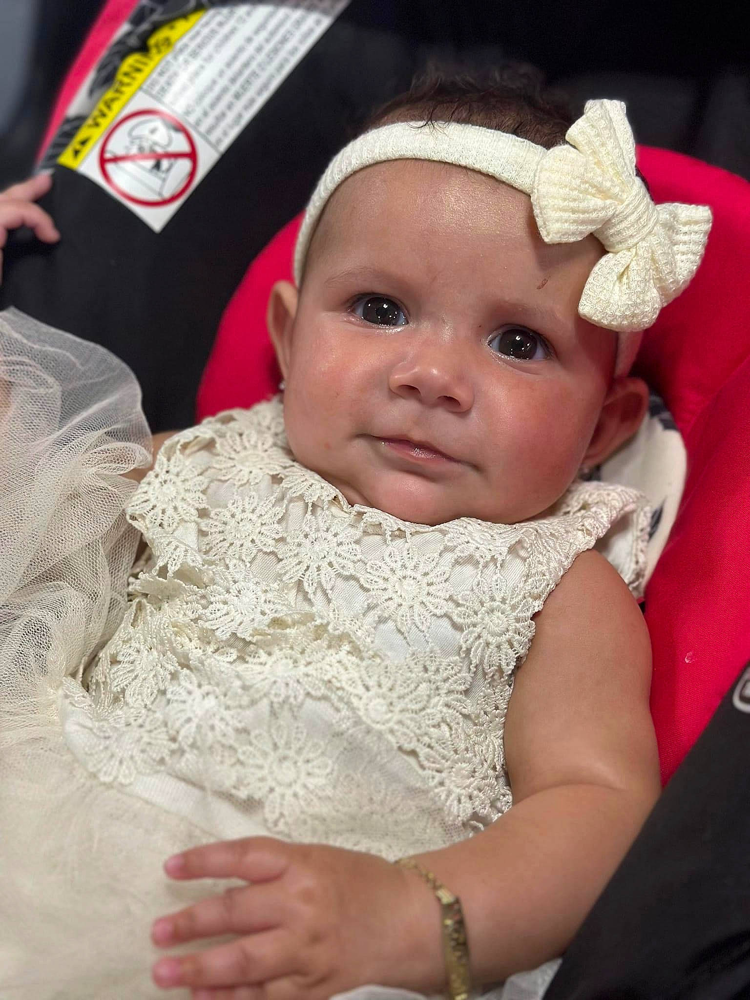 Cataleya is registered to the contest to win money with this photo: baby, baby_toddler_clothing, cap, cheek, child, comfort, dress, embellishment, event, fashion_accessory, fun, gesture, hair_accessory, happy, headwear, jewellery, linens, lip, person, skin