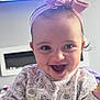 Rosie is registered to the contest to win money with this photo: baby, child, smile, happy, headband, pink, patterned_clothing, indoor, portrait, face, cute, laughing, infant, sitting, young_child, clothing, swans, person, head, expression