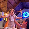 Ezekiel joined the competition — help win amazing prizes! baby, child, adult, church, indoor, stained_glass, crucifix, wooden_ceiling, happy, smiling, curly_hair, holding, lifting, person, light, window, religion, architecture, clothing, portrait