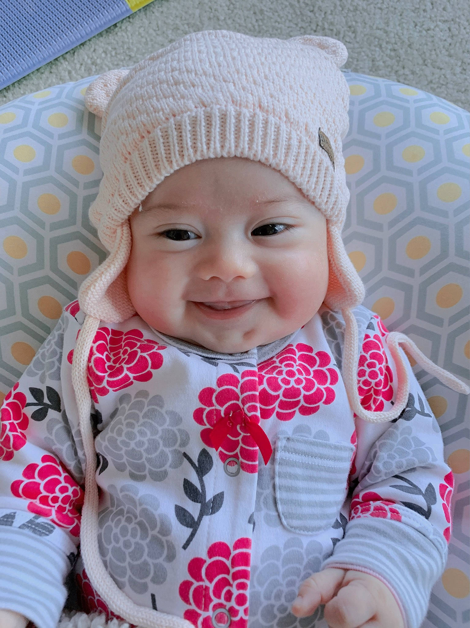 Nika is registered to the contest to win money with this photo: baby, beanie, beauty, bonnet, cap, cheek, child, hat, headgear, headwear, joy, knit_cap, knitting, outerwear, pattern, person, pink, skin, smile, textile