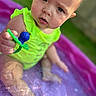Zyra is registered to the contest to win money with this photo: baby, bathing, bodypart, clothing, face, finger, flower, grass, hand, head, person, photography, plant, pool, portrait, sitting, summer, swimmingpool, swimwear, water