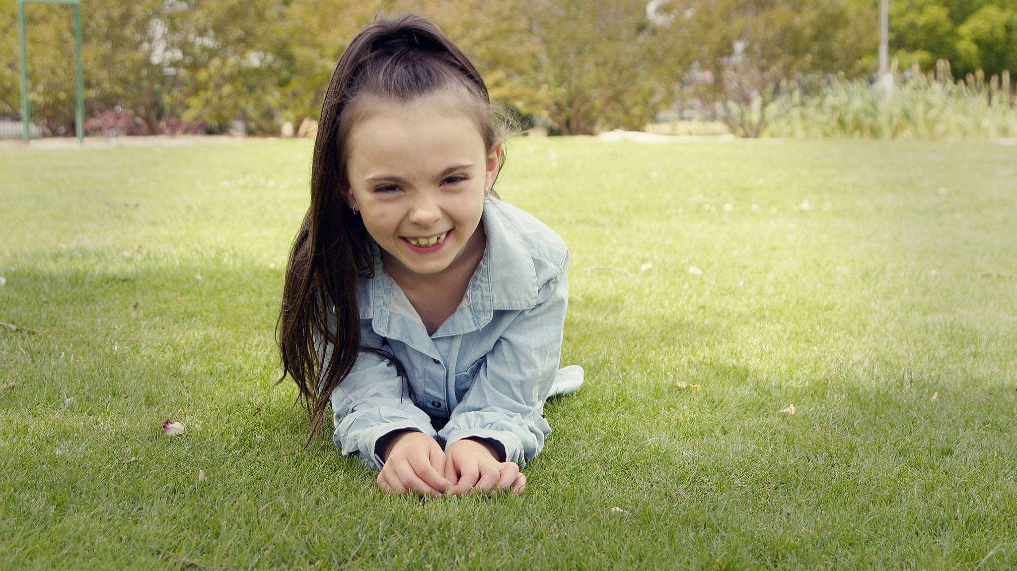 Lilly-rose is registered to the contest to win money with this photo: child, facial_expression, fun, grass, grass_family, grassland, green, happy, joy, lawn, meadow, people, people_in_nature, person, photograph, photography, play, sitting, skin, smile