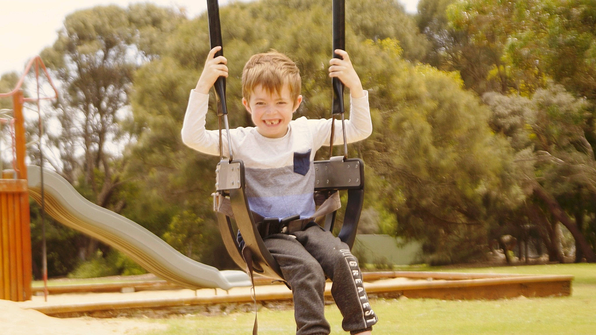 Lucas joined the competition — help win amazing prizes! child, child_model, city, fun, happy, human_settlement, jeans, joy, leisure, outdoor_play_equipment, person, play, playground, public_space, recreation, smile, swing, toddler, tree