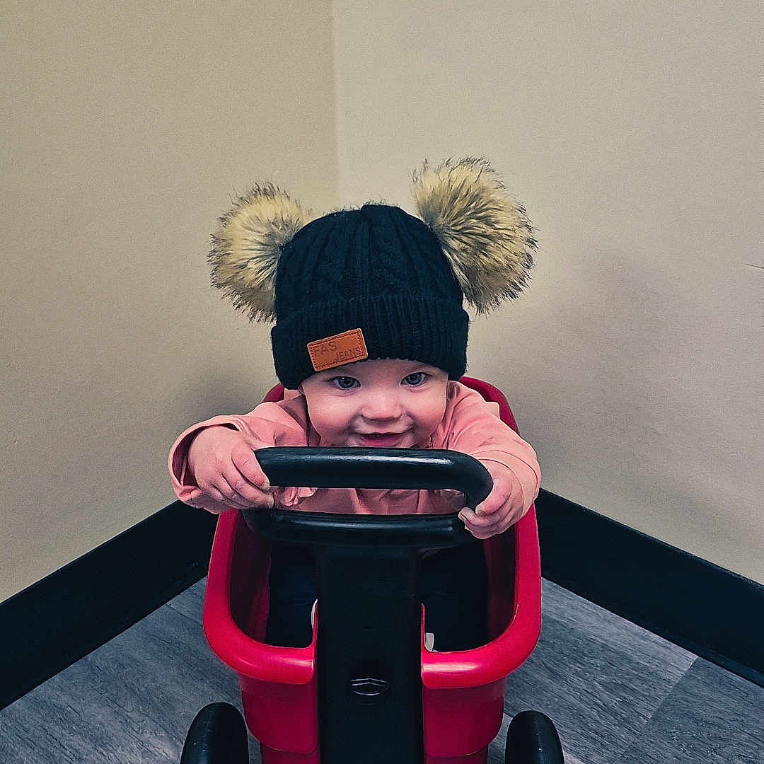 Harper joined the competition — help win amazing prizes! baby, beachwagon, cap, carriage, clothing, face, hardwood, hat, head, hood, machine, pants, person, plush, toy, transportation, vehicle, wagon, wheel, wood