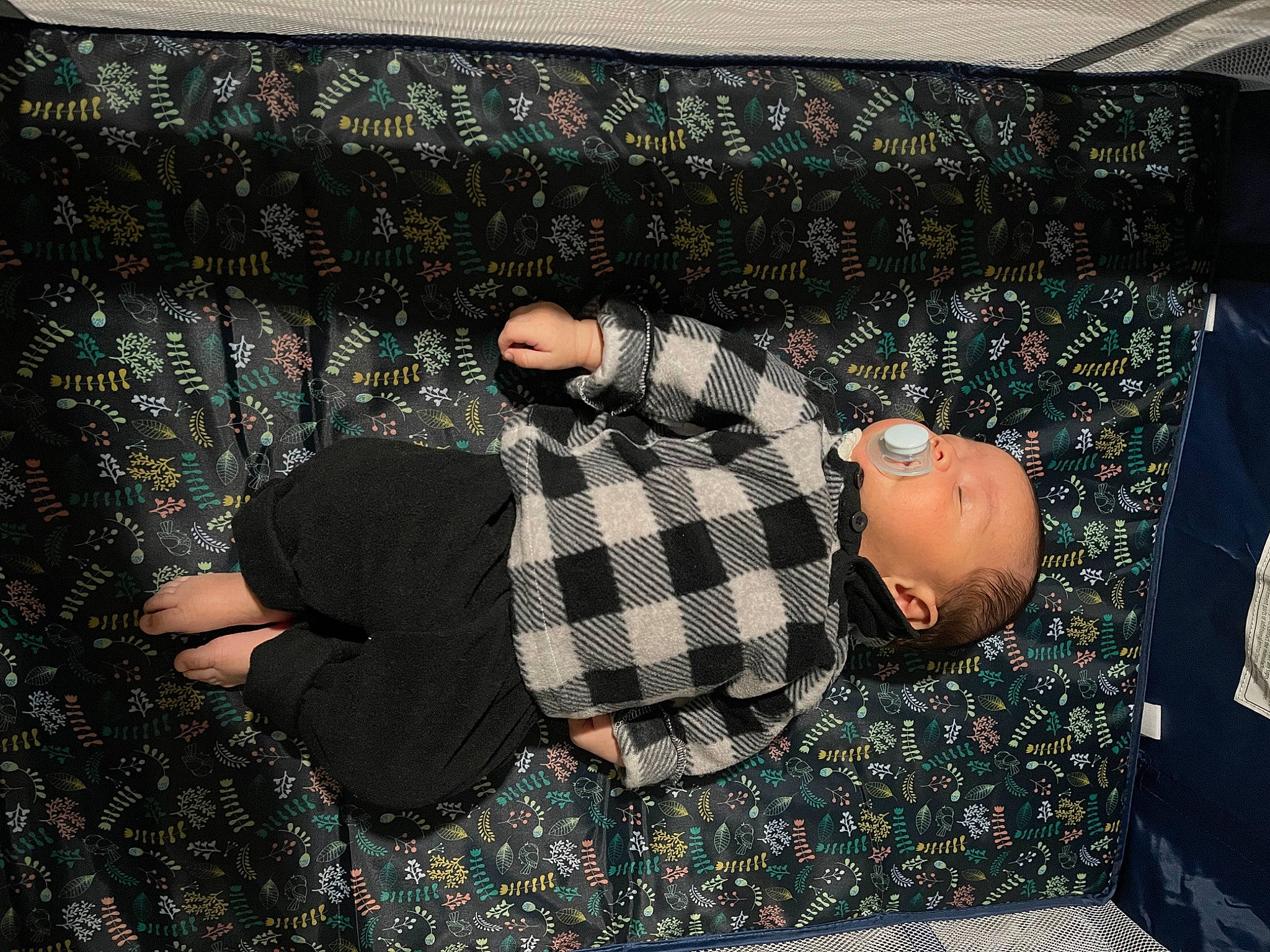 Milton Nathaniel is registered to the contest to win money with this photo: carpet, comfort, couch, floor, flooring, fun, grass, human_leg, linens, pattern, person, plaid, road_surface, room, sitting, t_shirt, tartan, textile, thigh, tints_and_shades