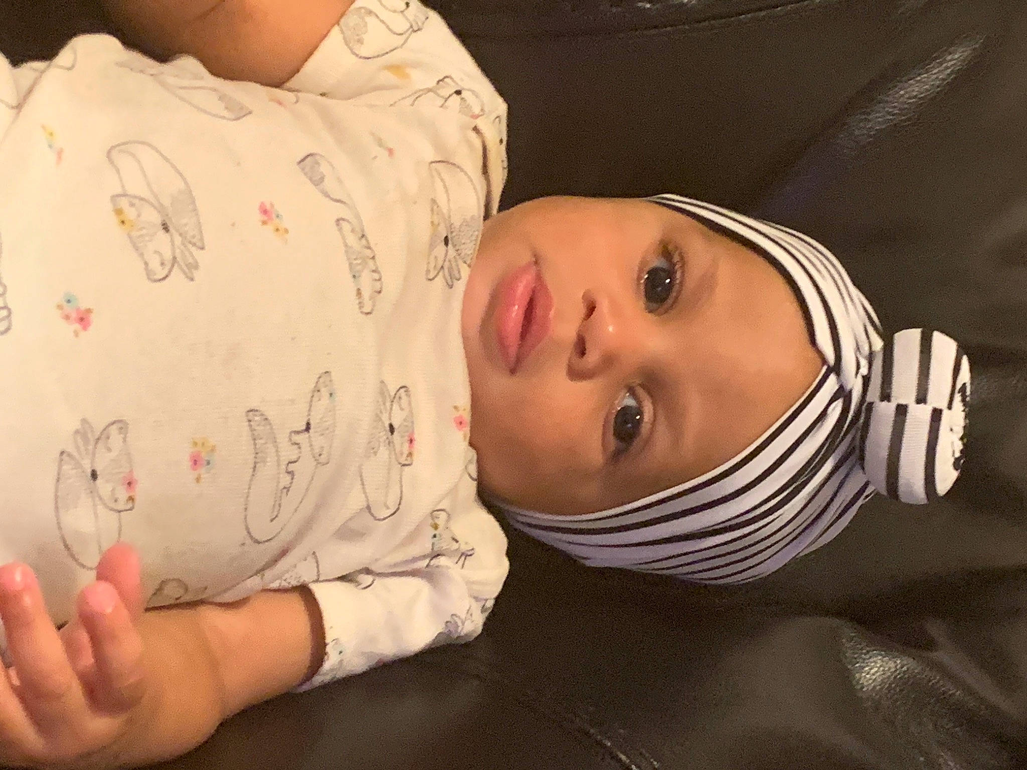 Mahogany is registered to the contest to win money with this photo: baby, baby_toddler_clothing, cheek, child, comfort, eye, eyelash, facial_expression, finger, flash_photography, glasses, hand, hat, headwear, lip, mouth, neck, nose, person, skin