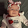 baby, infant, smile, headband, bow, clothing, red, white, face, cute, lying_down, blanket, soft, happy, closeup, person, portrait, indoors, child, lovebug