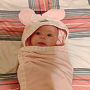 Dianne joined the competition — help win amazing prizes! baby, infant, wrapped, pink_blanket, hood, mouse_ears, cute, bedspread, striped, wide_eyes, surprised, curious, tongue, lying_down, soft, comfortable, child, person, indoors, portrait