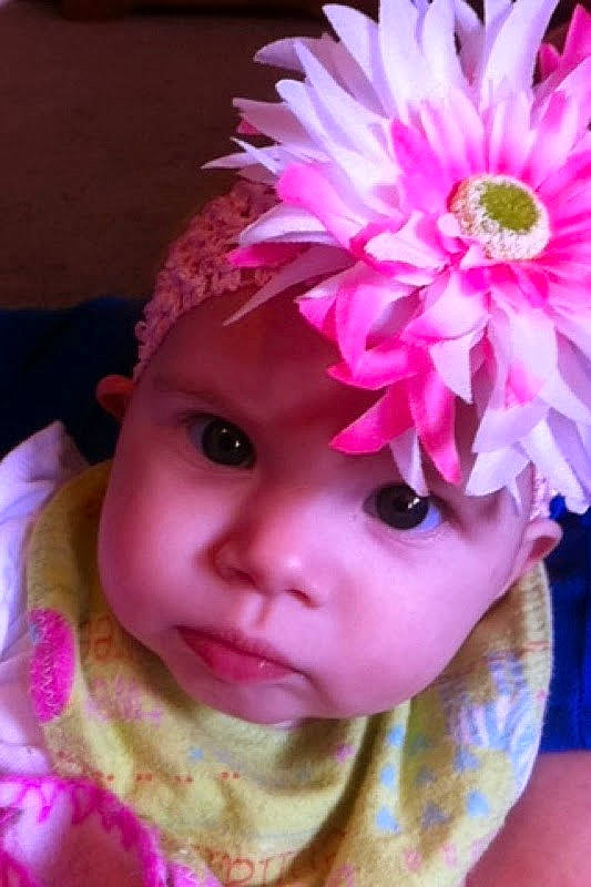 Journey joined the competition — help win amazing prizes! artificial_flower, baby, baby_toddler_clothing, cap, close_up, costume_hat, eye, eyelash, flower, headgear, headpiece, headwear, magenta, person, petal, pink, plant, purple, skin, toddler