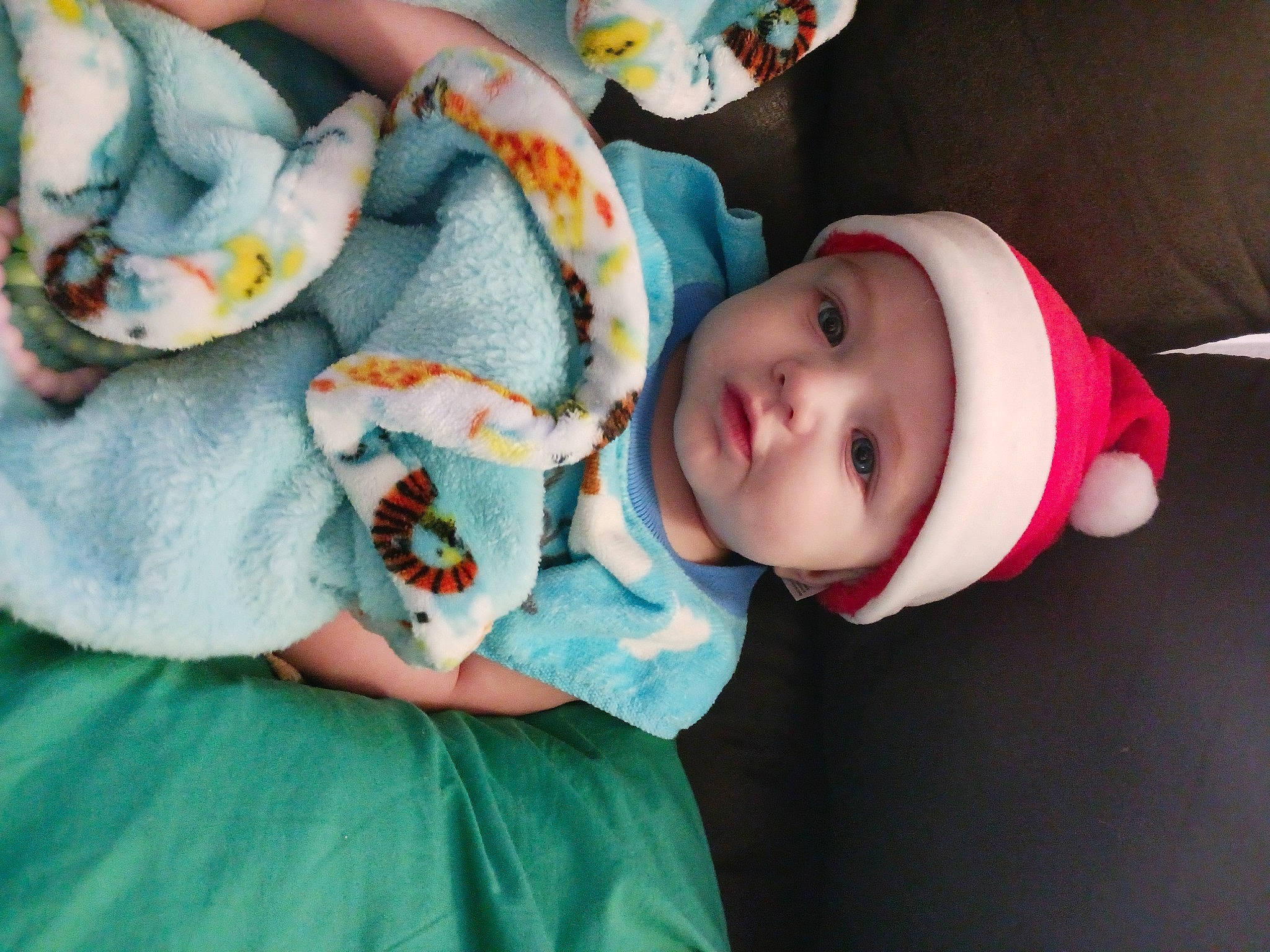 Julien is registered to the contest to win money with this photo: baby, baby_products, baby_toddler_clothing, cheek, child, comfort, dress, eye, fashion_accessory, hat, headgear, headwear, human_body, linens, pattern, person, room, skin, sun_hat, textile