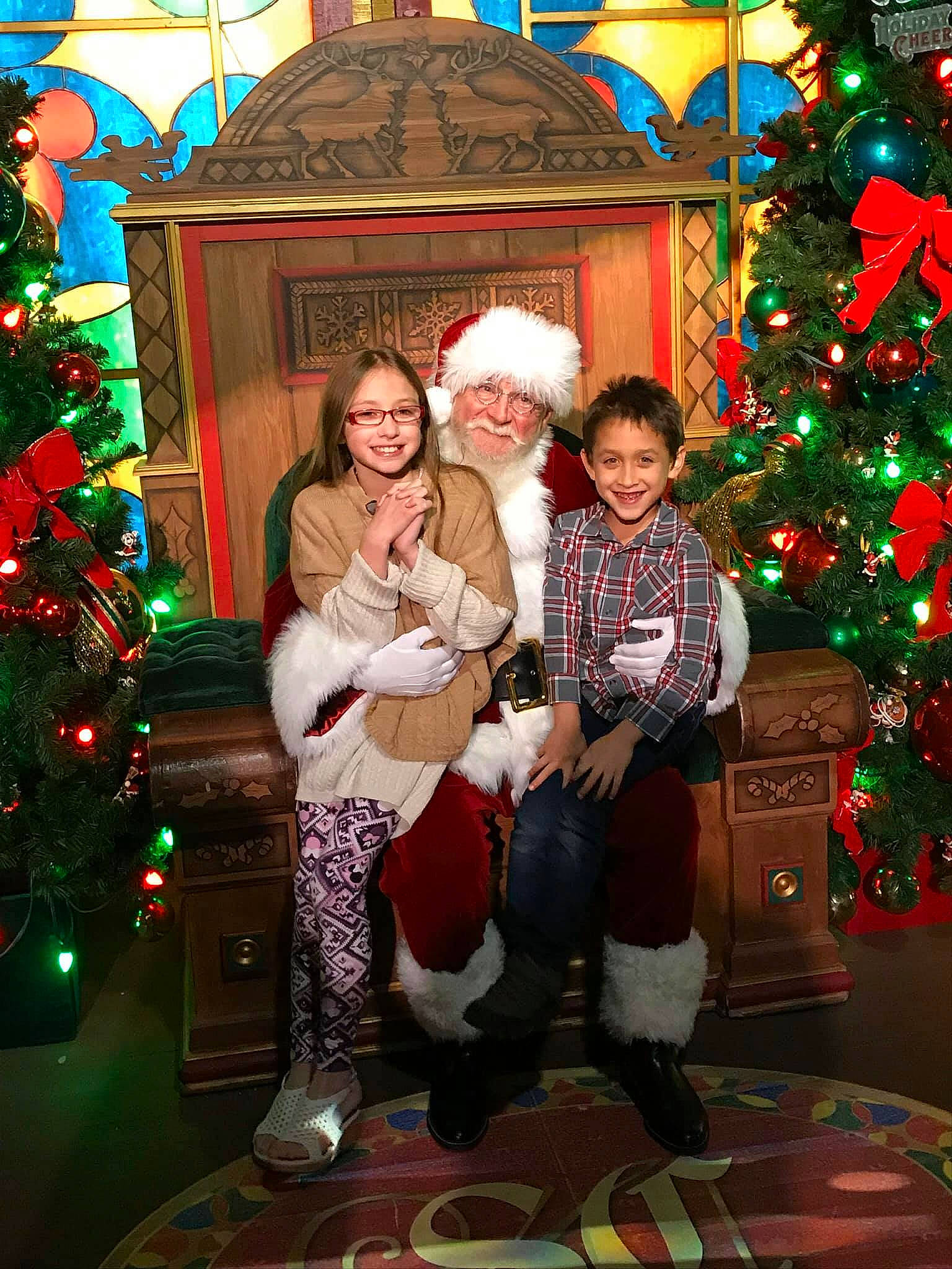 Grayson is registered to the contest to win money with this photo: christmas, christmas_decoration, christmas_eve, christmas_lights, christmas_ornament, christmas_tree, event, fir, fun, headwear, holiday, interior_design, joy, lap, person, photography, santa_claus, tradition, tree