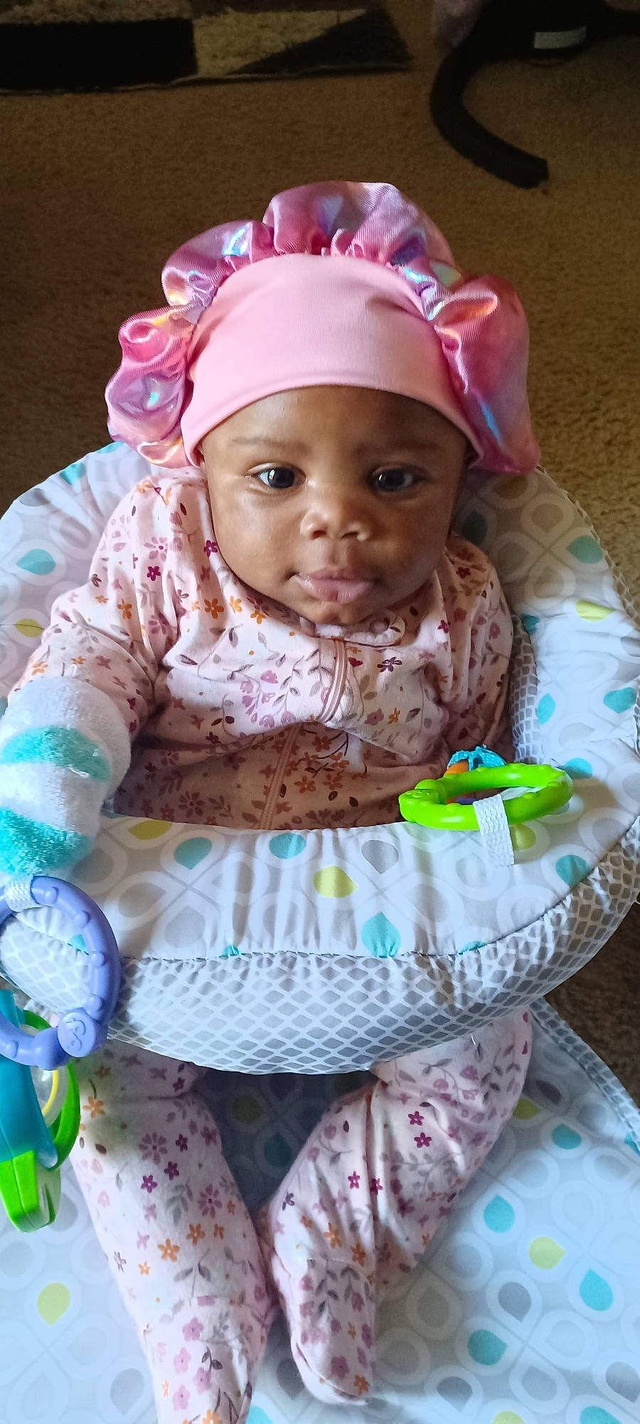 Dream is registered to the contest to win money with this photo: baby, baby_products, baby_toddler_clothing, cap, cheek, child, event, face, fashion_accessory, hair_accessory, happy, head, headgear, headwear, magenta, person, personal_protective_equipment, pink, purple, sitting
