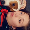 person, dog, face, pet, lying_down, closeup, cuddle, indoor, affection, casual_clothing, brown_hair, white_dog, brown_spot, hand, love, heart_overlay, relaxation, companion, cute, portrait