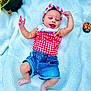 baby, infant, smiling, headband, red_checkered_top, denim_shorts, barefoot, blanket, knitted_blanket, outdoor, grass, plant_pot, cute, happy, posing, playful, child, person, portrait, summer