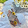 baby, infant, headband, blanket, sunflower, flower, basket, outdoor, grass, one_month, cute, patterned_clothing, lying_down, head, skin, feet, nature, celebration, soft_texture, milestone