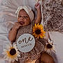 Zaryus joined the competition — help win amazing prizes! baby, infant, one_month, headband, flower, sunflower, blanket, patterned_clothing, cute, tongue_out, soft_texture, lying_down, child, adorable, newborn, headwear, floral, resting, skin, young_child