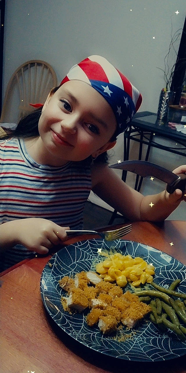 Autumn is registered to the contest to win money with this photo: cap, chair, cooking, cuisine, deep_frying, desk, dish, food, frying, happy, hat, headwear, ingredient, joy, person, plate, recipe, shorts, smile, table